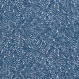 Detail of fabric in a scrolling stem and leaf print in navy on a white field.
