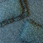 Two ruffled throw pillows lay on a fabric surface. All are upholstered in the same scrolling stem and leaf print.