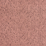 Detail of fabric in a scrolling stem and leaf print in coral on a maroon field.