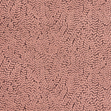 Detail of fabric in a scrolling stem and leaf print in coral on a maroon field.