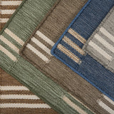 Stacked broadloom carpet samples in a handsome stacked stripe pattern in various colors. 