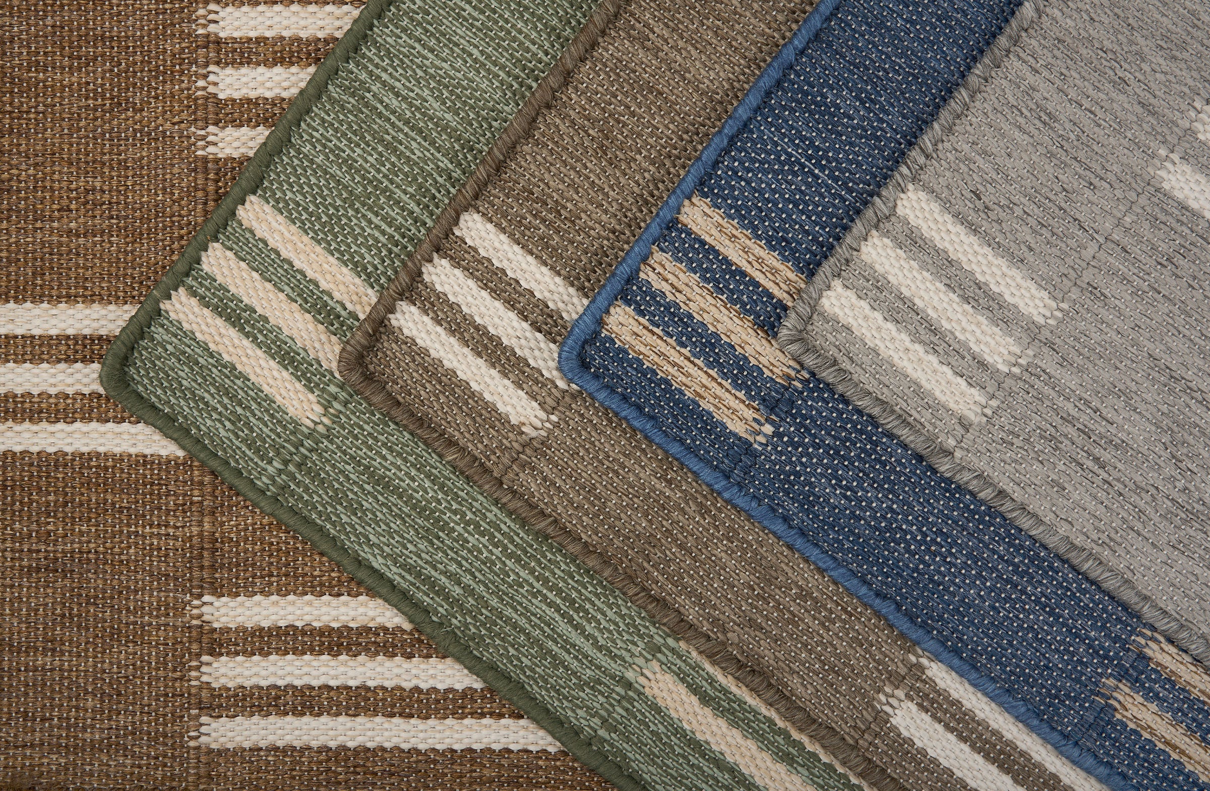 Stacked broadloom carpet samples in a handsome stacked stripe pattern in various colors. 