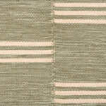 Broadloom flatweave carpet in a broken stripe in white on a sage green field.