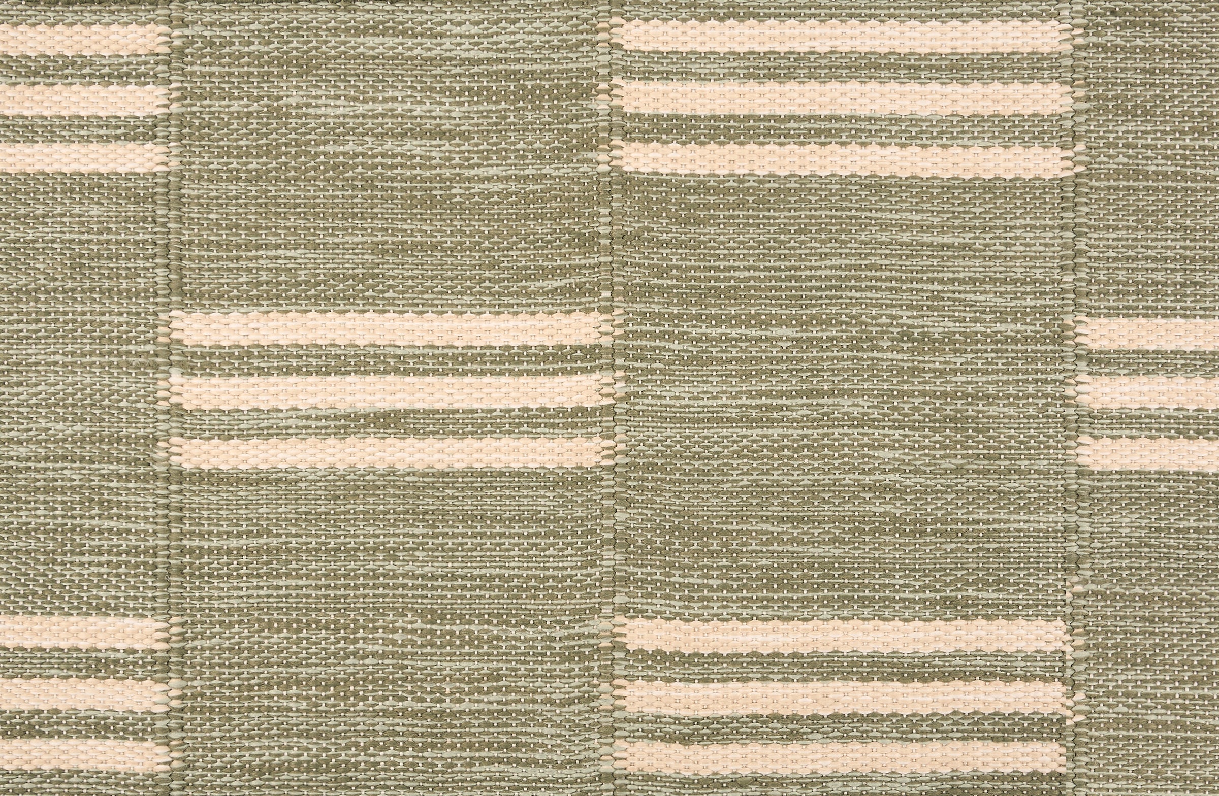 Broadloom flatweave carpet in a broken stripe in white on a sage green field.