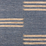 Broadloom flatweave carpet in a broken stripe in white on a blue field.