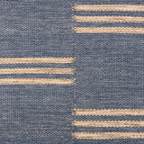 Broadloom flatweave carpet in a broken stripe in white on a blue field.