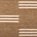 Broadloom flatweave carpet in a broken stripe in white on a brown field.