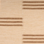 Broadloom flatweave carpet in a broken stripe in brown on a beige field.