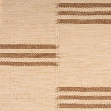 Broadloom flatweave carpet in a broken stripe in brown on a beige field.