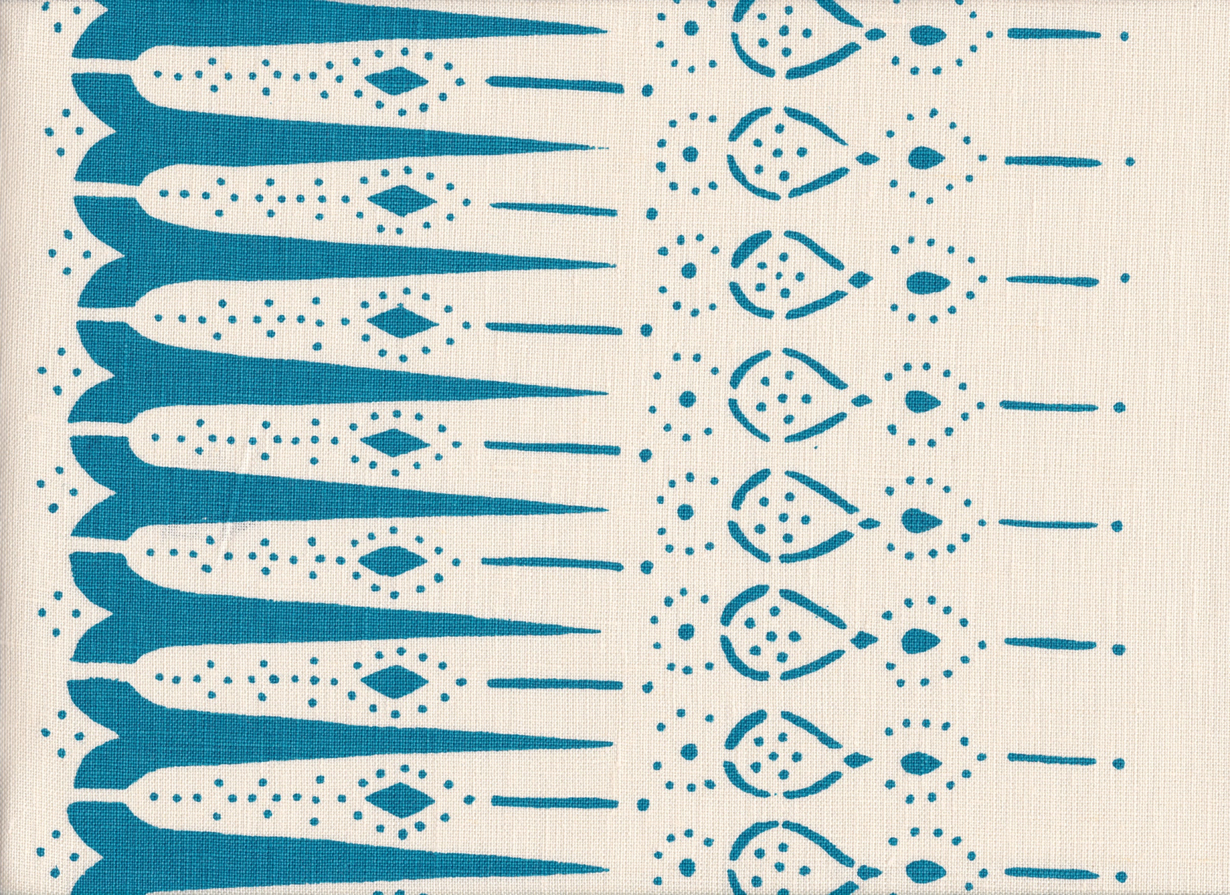 Detail of fabric in a bordered teardrop print in turquoise on a cream field.