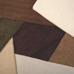 Broadloom carpet samples in an array of solid colors. 