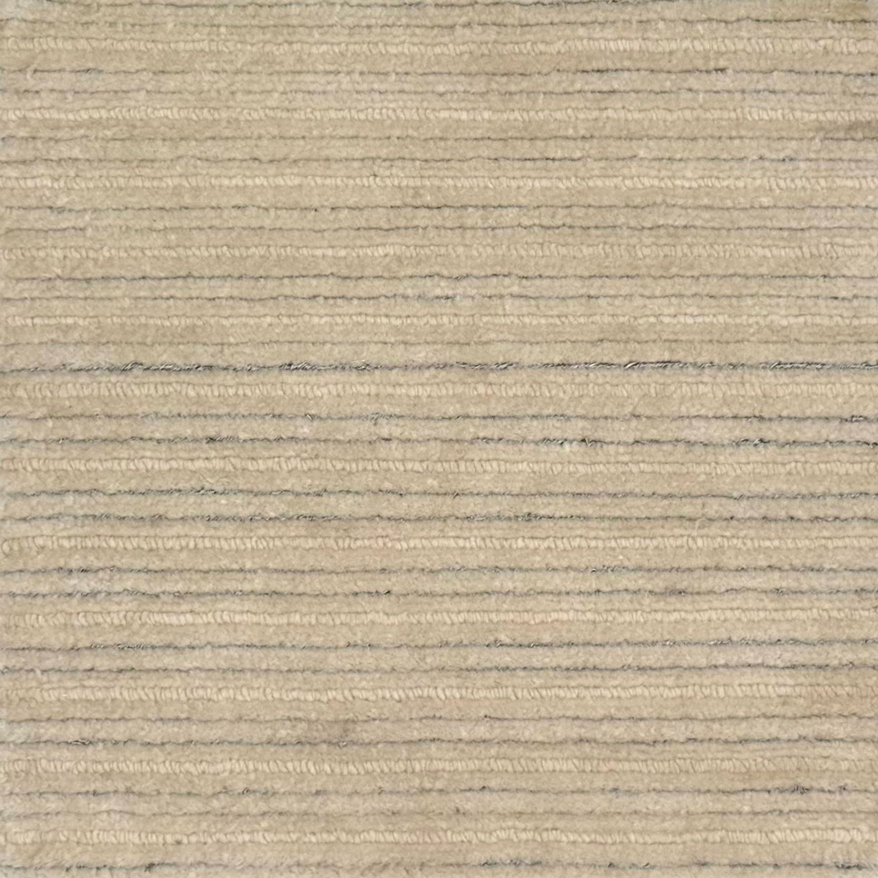 A close-up of a handknotted rug in warm beige with thin horizontal silver stripes.