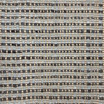 Handwoven rug with blue and charcoal stripes with a beige satin warp over top. 