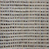 Handwoven rug with blue and charcoal stripes with a beige satin warp over top. 