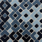 Handknotted rug with raised arrow design in shades of blue.