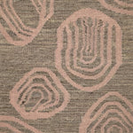Handwoven rug with geometric pattern in grey and pink tones
