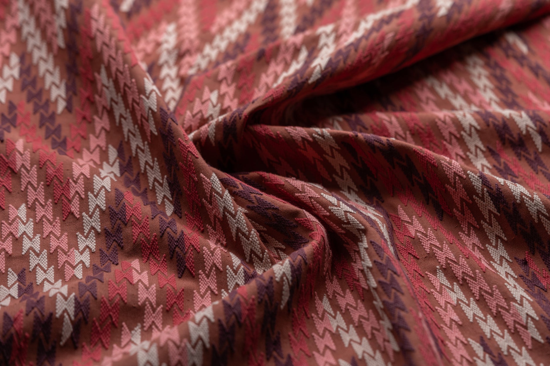 Close-up of patterned fabric with red and beige colors