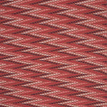 Woven fabric with geometric zig zag pattern in  shades of pink on red. 