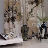 White bench, ceramic urn and rattan side table with vase in front of two curtain panels of a bold monochrome watercolor floral mural.