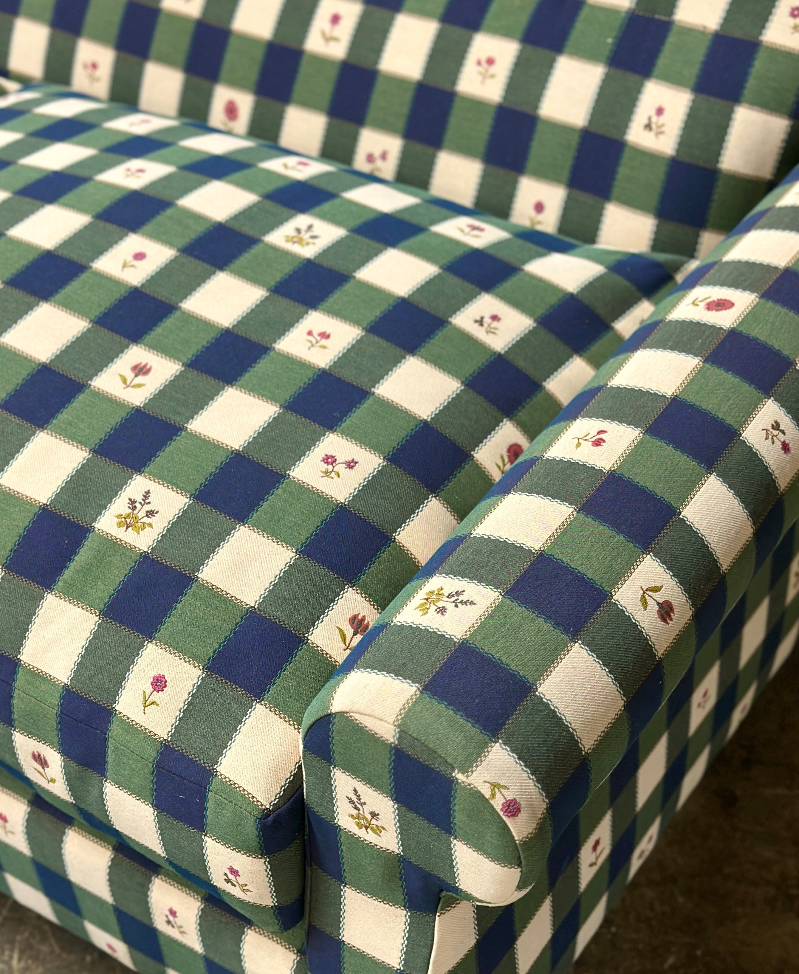 Green and blue checkered sofa with floral patterns