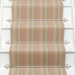 Striped flatweave runner in red green blue orange on white staircase