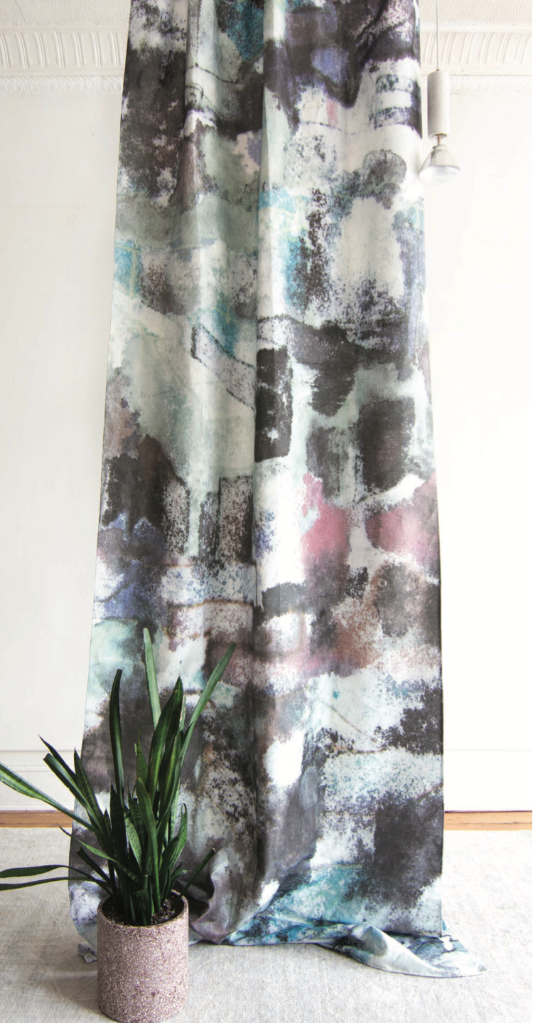 Abstract patterned curtain with a plant in the foreground