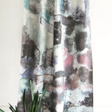 Abstract patterned curtain with a plant in the foreground