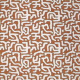 Fabric in an abstract meandering shape print in white and sage on a rust field.