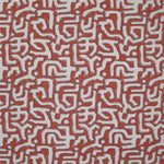 Fabric in an abstract meandering shape print in white and gray on a red field.
