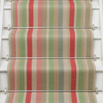 Striped flatweave runner in green pink blue red yellow on white staircase