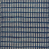 Textured rug with a blue and ivory checker pattern