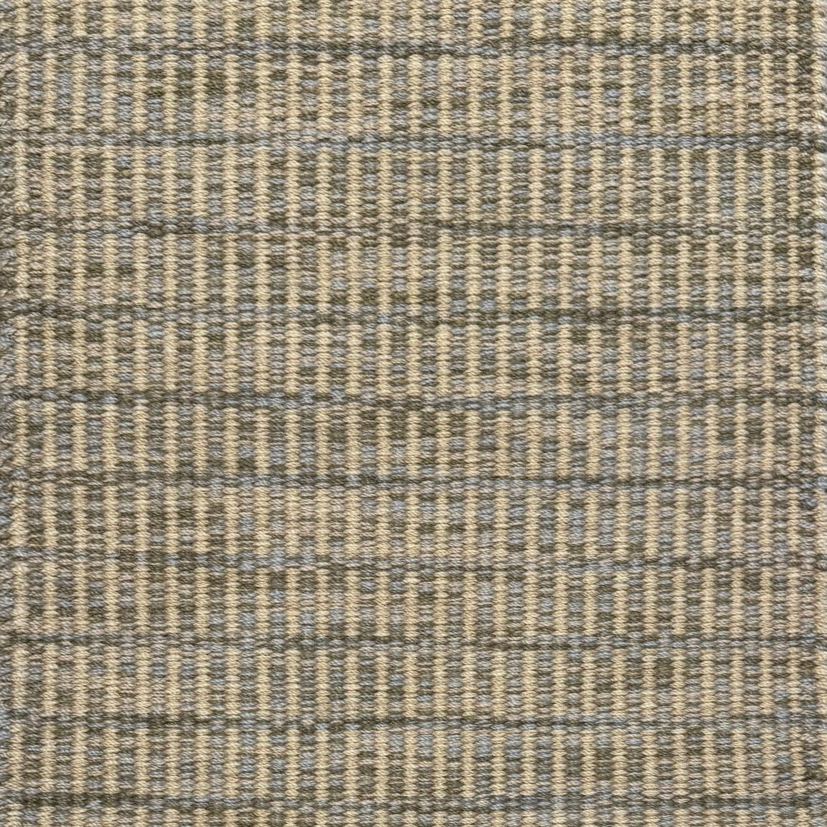 Textured rug with a grey and beige checker pattern