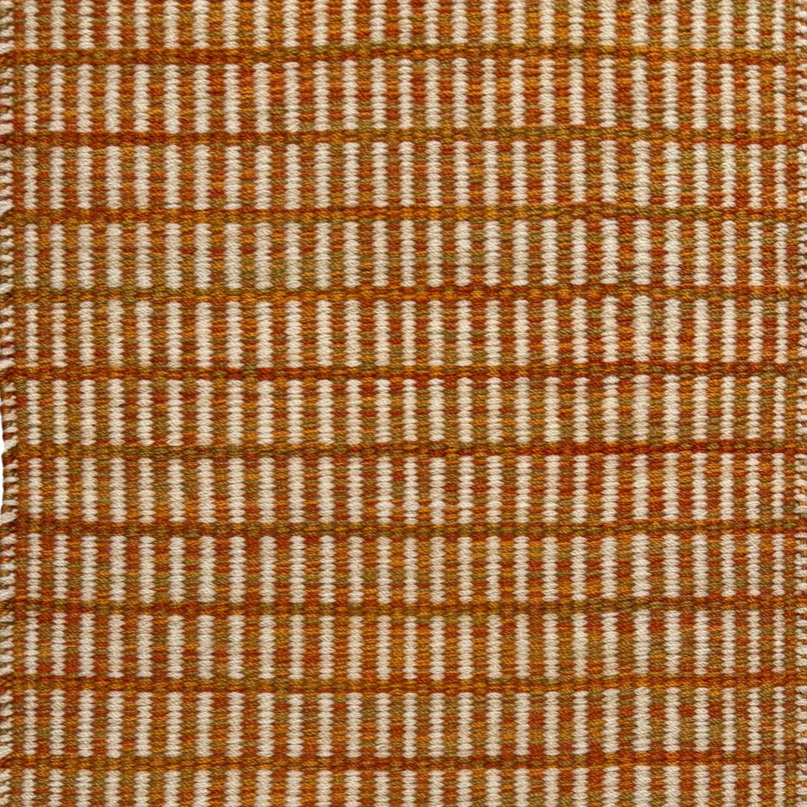 Textured rug with an orange and beige  checker pattern