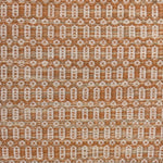 Handwoven wool rug with an oval and diamond lattice pattern in shades of orange and tan. 