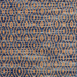 Handwoven wool rug with undulating oval stripe in shades of blue on an orange field. 