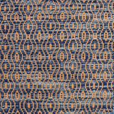 Handwoven wool rug with undulating oval stripe in shades of blue on an orange field. 