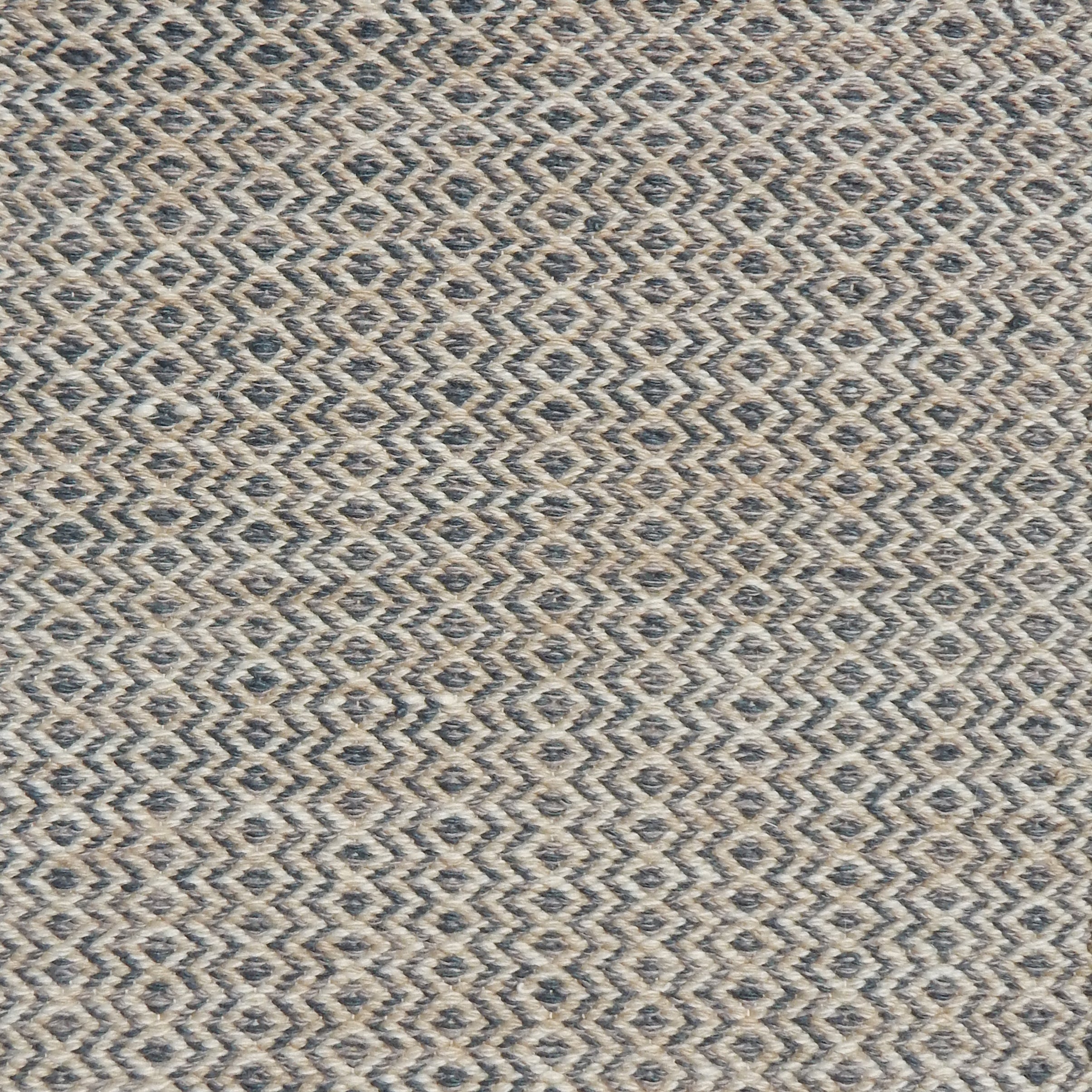 Flatweave rug with an diamond stripe pattern in cream and slate blue.