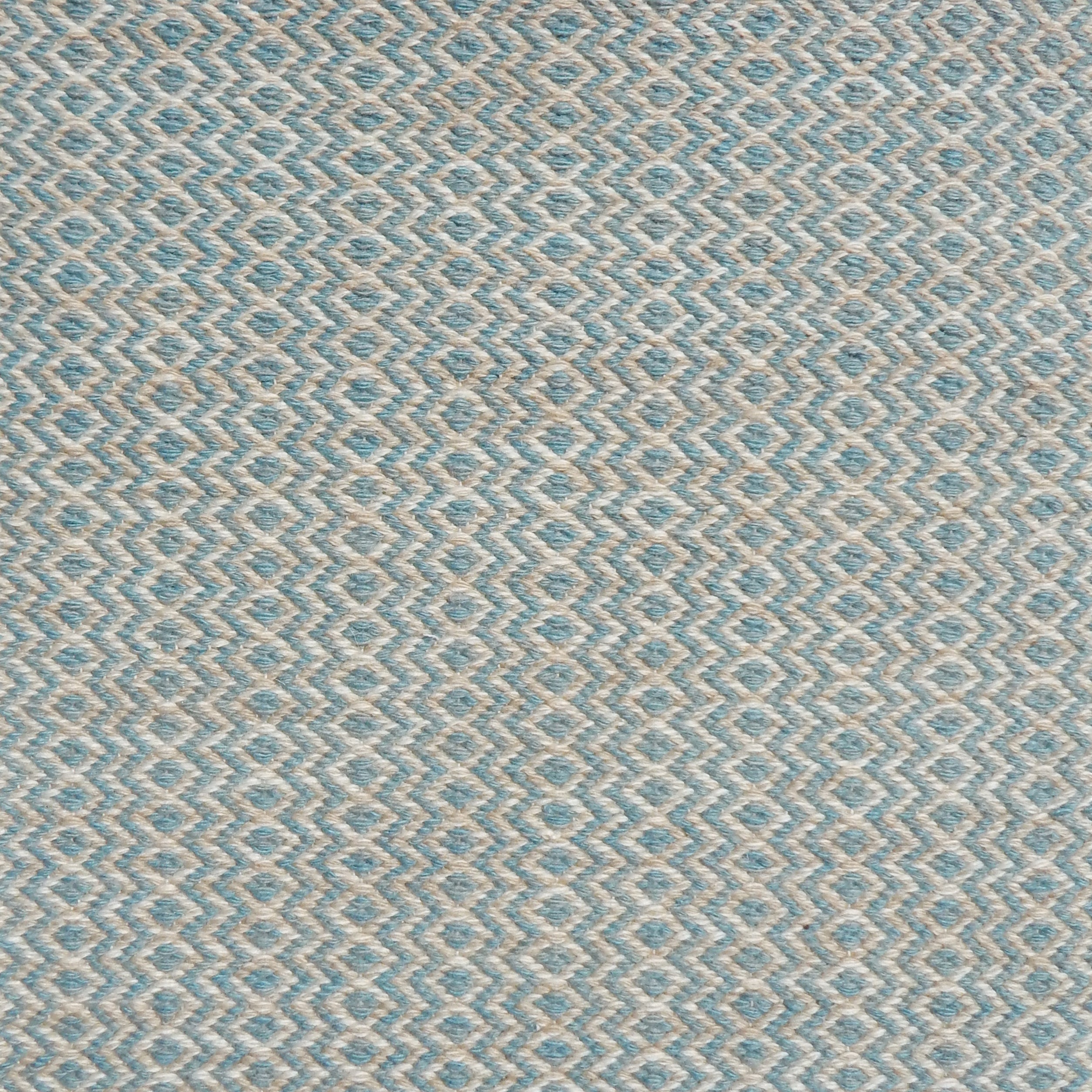 Flatweave rug with an diamond stripe pattern in cream and turquoise