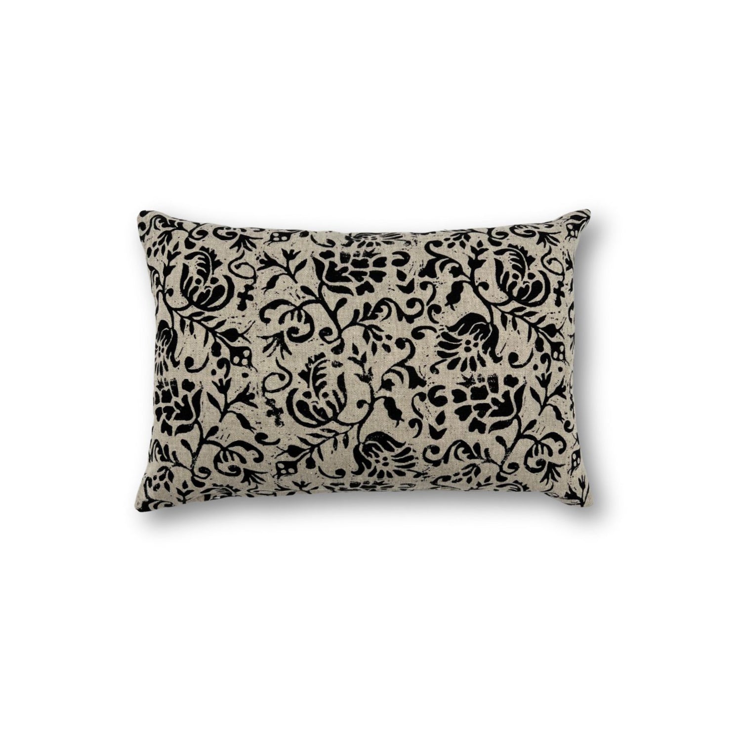 Rectangular throw pillow with a floral scroll filigree pattern in black against a natural linen background. 