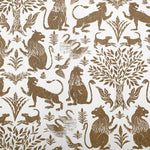 Wallpaper in a lion and plant print in brown on a white field.