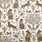 Wallpaper in a lion and plant print in brown on a white field.