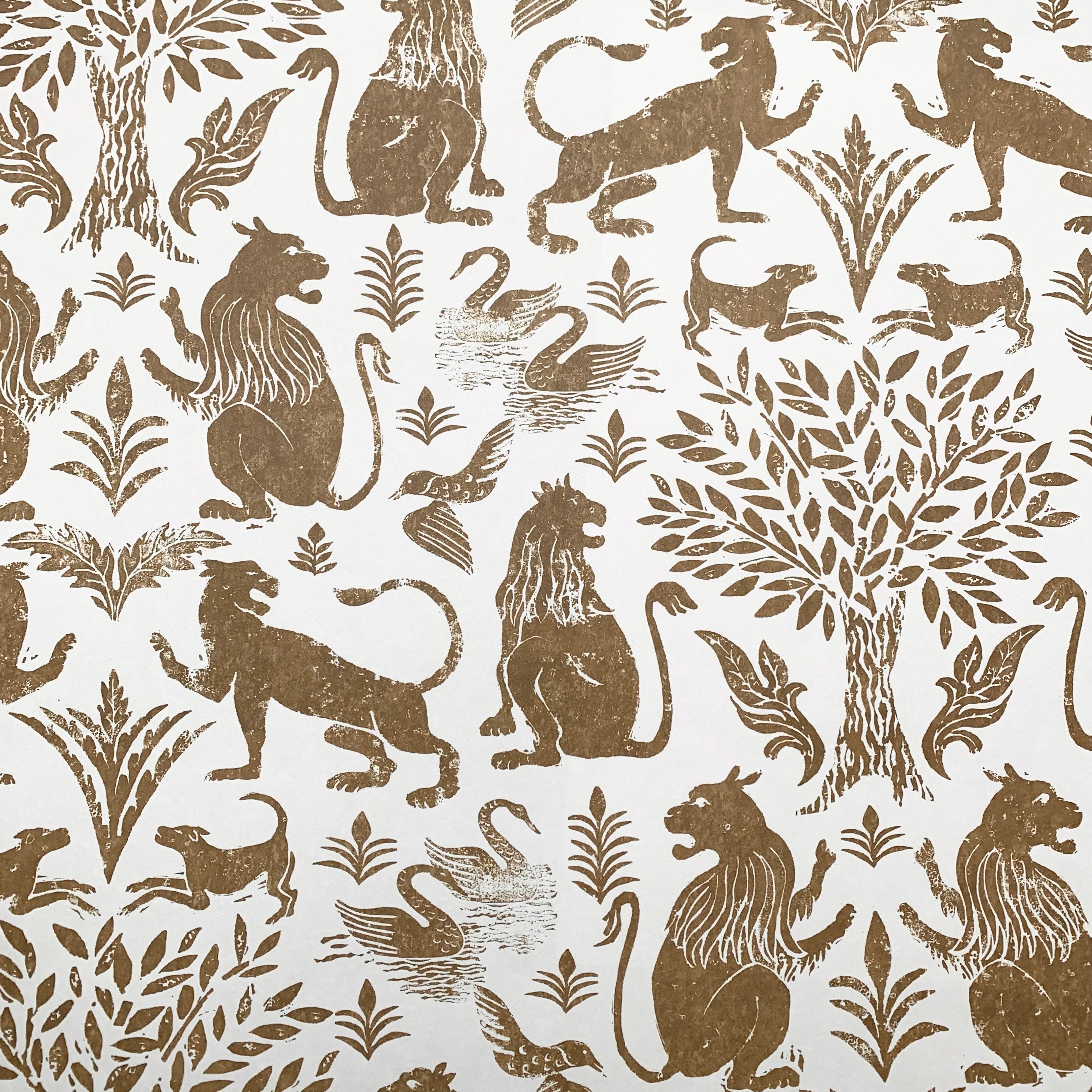 Wallpaper in a lion and plant print in brown on a white field.