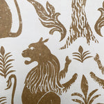 Detail of wallpaper in a lion and plant print in brown on a white field.