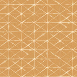 Detail of fabric in a mottled lattice print in white on a burnt orange field.