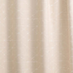 Draped fabric yardage in a mottled lattice print in white on a cream field.