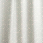 Draped fabric yardage in a mottled lattice print in white on a light blue field.