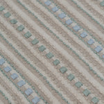 Detail of a dimensional embroidered fabric in an irregular stripe pattern in shades of taupe, cream, sage green and pale blue.