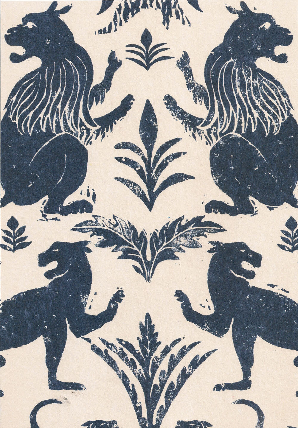 Close-up of wallpaper in a lion and plant print in navy on a cream field.