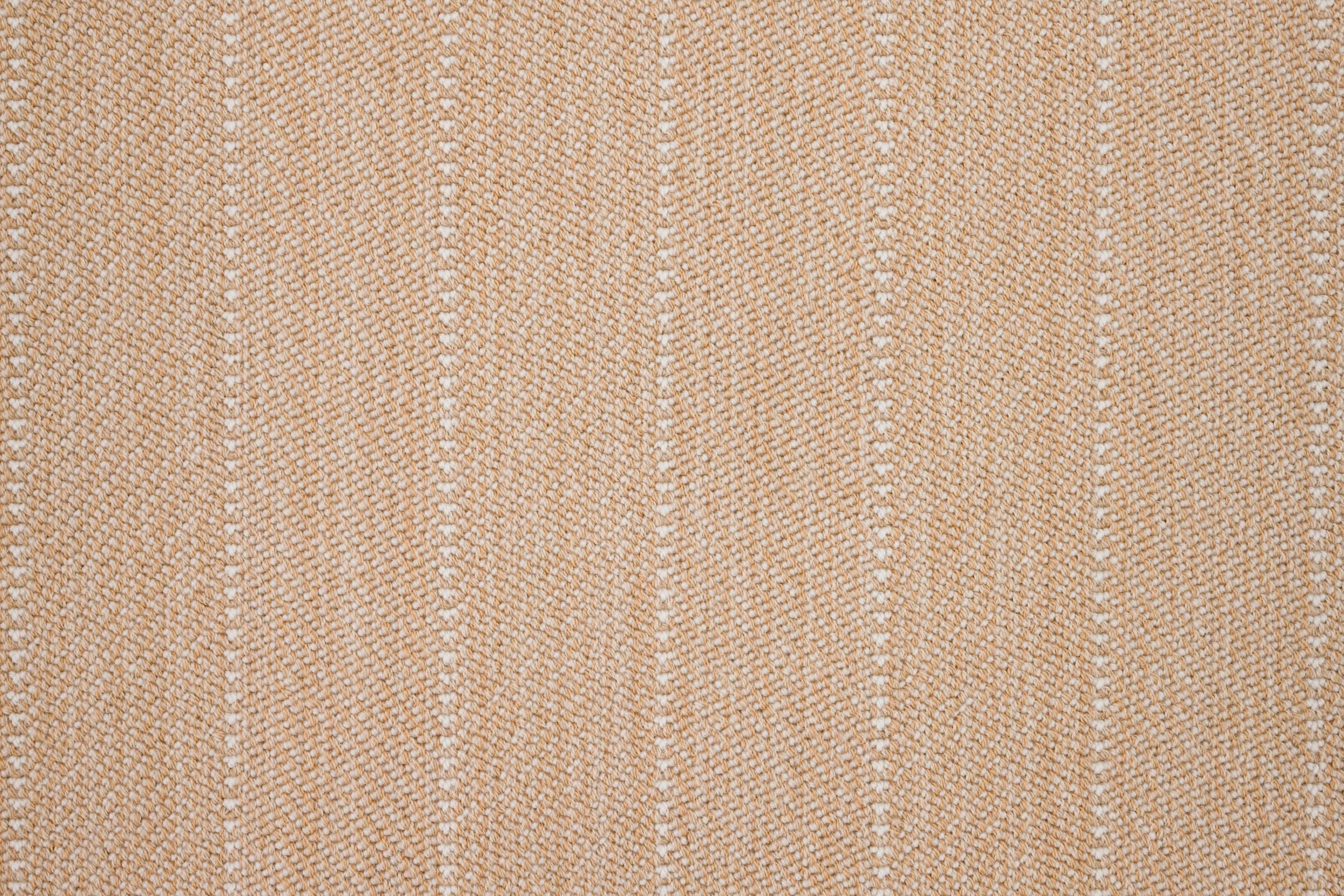 Close-up of a striped herringbone broadloom in light orange.