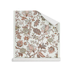 Roll of wallpaper in scrolling floral vine pattern in clay pink, grey tan and brown on white. 